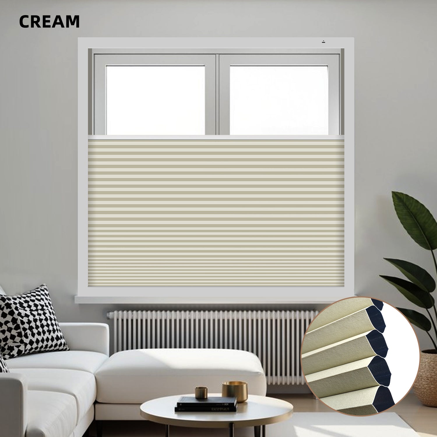 Cream-colored blackout honeycomb shades on a window with a modern living room setting.