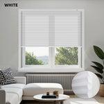 Living room with white window cordless motorized cellular shades, sofa, and decor elements.