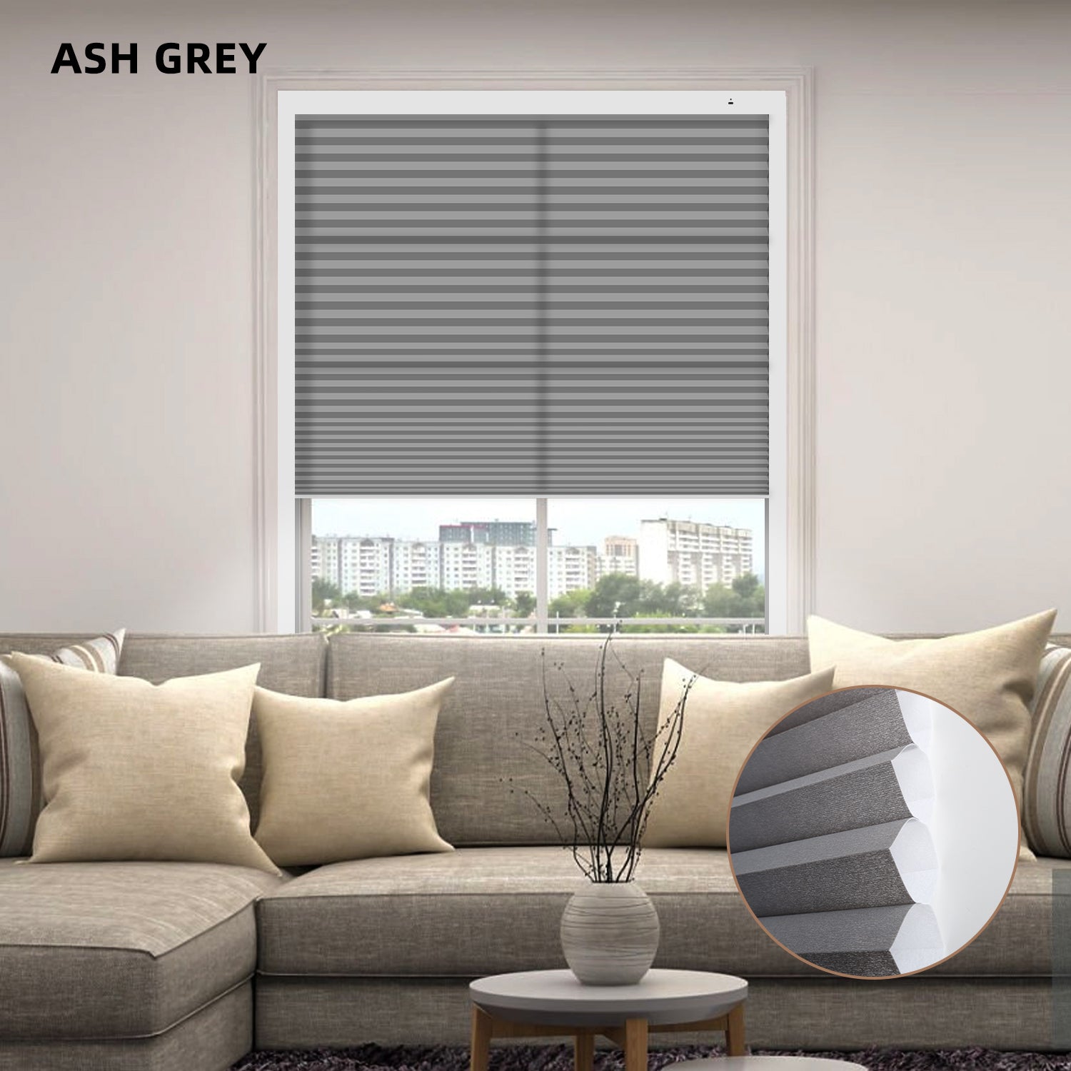 Ash grey window blinds in a living room setting with a sofa and decorative elements.