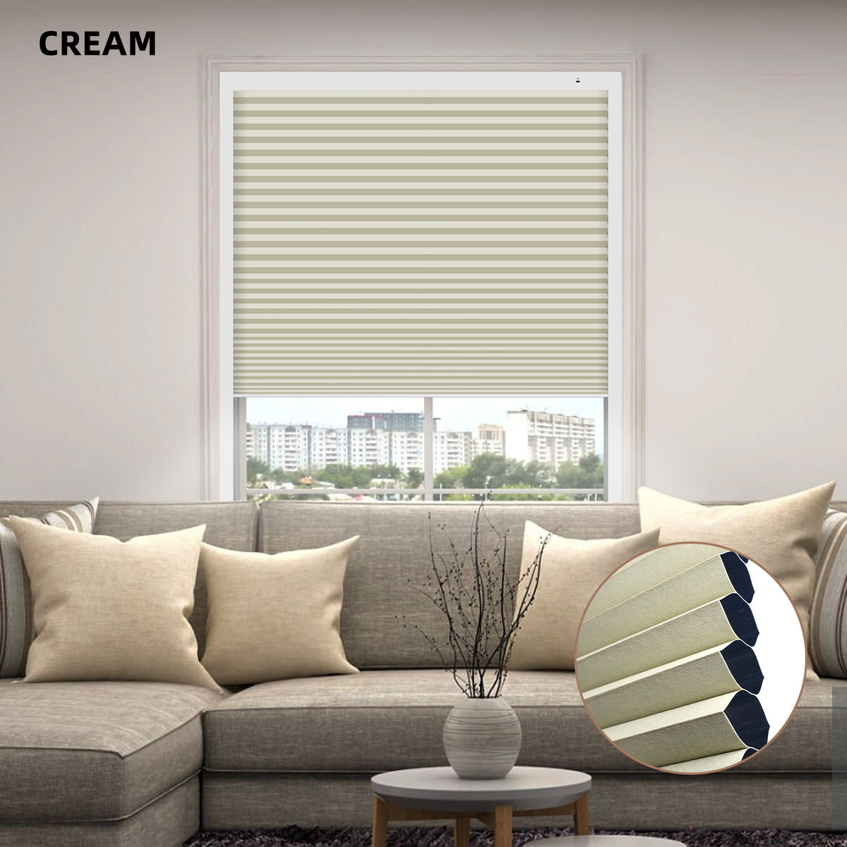 Living room with a gray sofa, cream-colored window custom size cellular blinds, and a small round table with a vase.