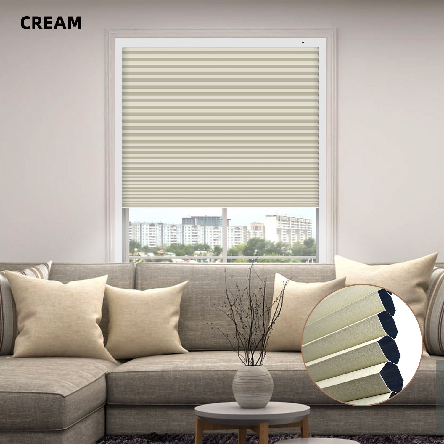 Living room with a gray sofa, cream-colored window custom size cellular blinds, and a small round table with a vase.