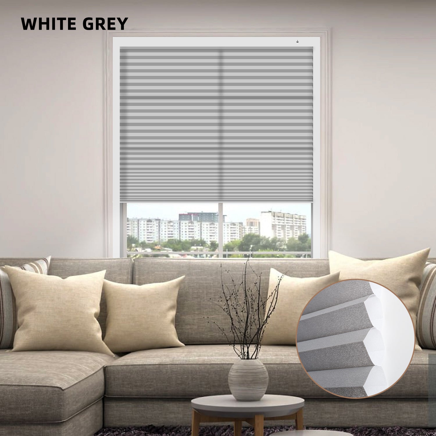 iving room with a window featuring white and gray blinds, a sofa with beige pillows, and a small table with a decorative vase.