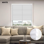 White window motorized cellular honeycomb shades in a living room with a gray sofa and decorative elements.