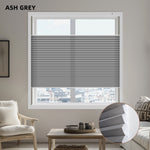 Living room with ash grey window light filtering honeycomb shades and modern decor.